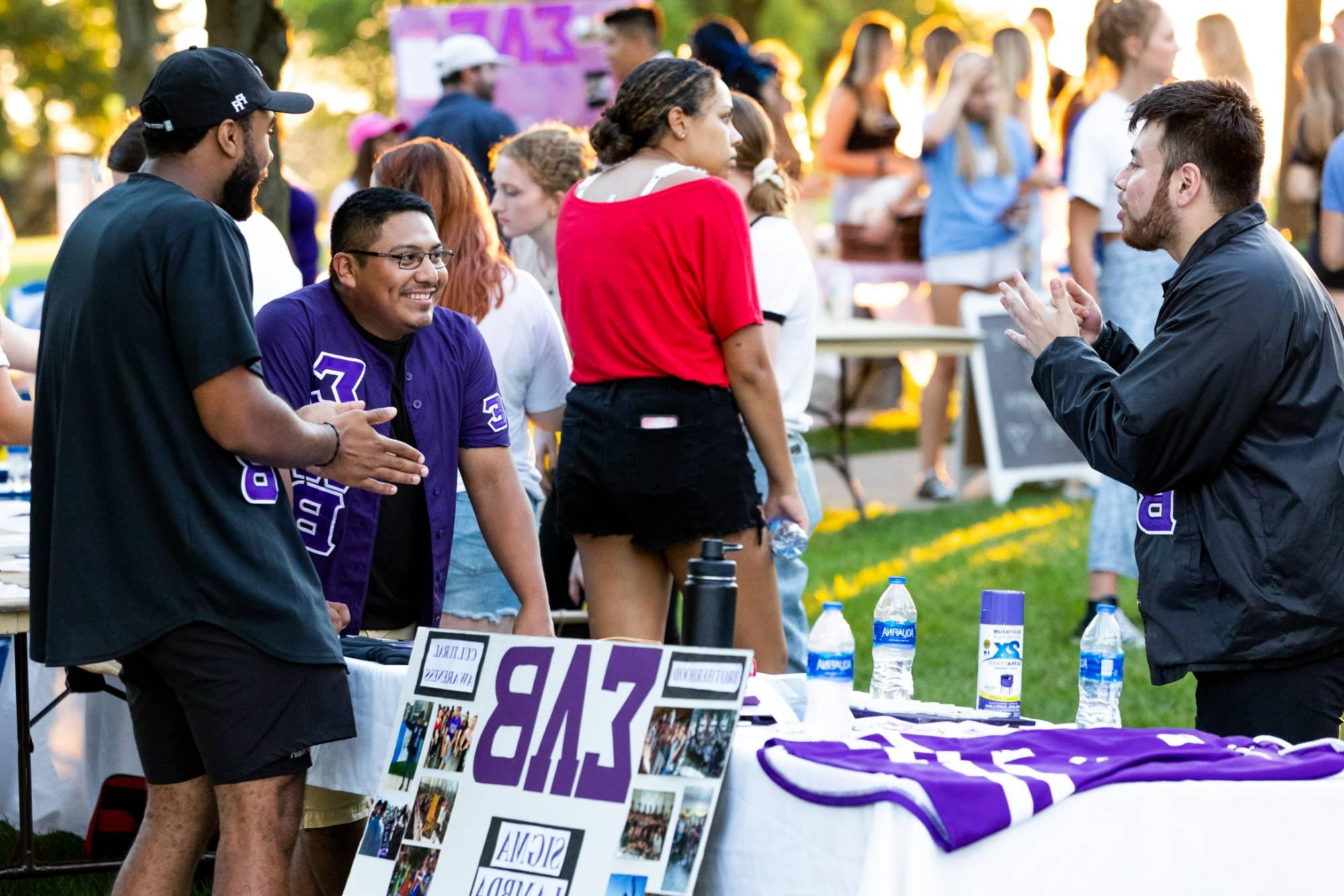 Students laughing and talking at the Greek Block Party